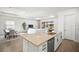 Kitchen island with stainless appliances overlooks dining and living areas, with lots of natural light at 15916 Sugar Hill Dr, Punta Gorda, FL 33982