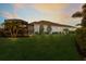 Expansive backyard with manicured lawn, lush tropical landscaping and screened-in patio at 16734 Collingtree Xing, Lakewood Ranch, FL 34202