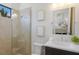 Stylish bathroom featuring sleek vanity, tiled shower and decorative framed mirrors at 16734 Collingtree Xing, Lakewood Ranch, FL 34202
