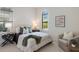 Cozy bedroom with neutral tones features an arched window with plantation shutters at 16734 Collingtree Xing, Lakewood Ranch, FL 34202