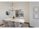 Dining room with modern chandelier, window view, and stylish decor at 16734 Collingtree Xing, Lakewood Ranch, FL 34202