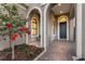 Beautiful front entrance with arched columns, a flower bed, and a blue front door at 16734 Collingtree Xing, Lakewood Ranch, FL 34202