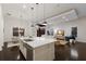 Open-concept kitchen with island and stainless sink, flowing to living and dining areas at 16734 Collingtree Xing, Lakewood Ranch, FL 34202