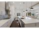 Modern kitchen with stainless appliances and seamless flow to dining and living areas at 16734 Collingtree Xing, Lakewood Ranch, FL 34202