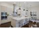 Spacious kitchen featuring a large island with seating, stainless steel appliances, and modern lighting at 16734 Collingtree Xing, Lakewood Ranch, FL 34202
