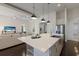 Bright kitchen with a large island and stainless steel appliances, seamlessly integrated into the living space at 16734 Collingtree Xing, Lakewood Ranch, FL 34202