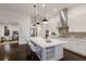 Bright kitchen featuring a large island, stainless steel appliances, and modern lighting at 16734 Collingtree Xing, Lakewood Ranch, FL 34202