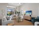 Spacious living room with a large window, white sofas, modern decor, and a ceiling fan at 16734 Collingtree Xing, Lakewood Ranch, FL 34202
