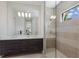 Modern main bathroom with double sinks, a large mirror, and a glass-enclosed shower at 16734 Collingtree Xing, Lakewood Ranch, FL 34202