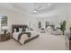 Spacious main bedroom features tray ceilings, neutral walls, plantation shutters, and sitting area at 16734 Collingtree Xing, Lakewood Ranch, FL 34202