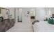 View of a neutral-toned main bedroom with ensuite bath featuring a decorative art piece at 16734 Collingtree Xing, Lakewood Ranch, FL 34202