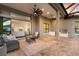 Covered outdoor kitchen and dining area on brick patio, excellent for backyard entertaining at 16734 Collingtree Xing, Lakewood Ranch, FL 34202