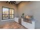 Outdoor kitchen features modern appliances and marble countertops with views of the home's interior at 16734 Collingtree Xing, Lakewood Ranch, FL 34202