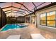 Backyard pool with brick patio, spa, and outdoor kitchen on an estate lot at 16734 Collingtree Xing, Lakewood Ranch, FL 34202