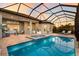 Backyard pool with covered patio and outdoor kitchen, great for entertaining guests at 16734 Collingtree Xing, Lakewood Ranch, FL 34202