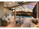 Screened-in patio with ceiling fans and outdoor kitchen overlooks pool and spa at sunset at 16734 Collingtree Xing, Lakewood Ranch, FL 34202