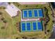 Aerial view of green and blue community tennis and pickleball courts, plus a sand volleyball court at 16734 Collingtree Xing, Lakewood Ranch, FL 34202