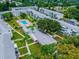 Aerial view of the community pool, shuffleboard, walkways and manicured green spaces at 1815 Restful Dr # N-27, Bradenton, FL 34207