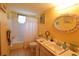 Bright bathroom featuring tiled floors, a shower-tub combo, vanity with a decorative framed mirror, and yellow painted walls at 1815 Restful Dr # N-27, Bradenton, FL 34207