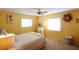 Sunny bedroom featuring neutral carpet, bright yellow walls, and closet at 1815 Restful Dr # N-27, Bradenton, FL 34207