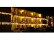 Exterior of the condo building illuminated with holiday lights and parking area at 1815 Restful Dr # N-27, Bradenton, FL 34207