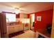 Efficient kitchen featuring bright red walls, essential appliances and laminate flooring at 1815 Restful Dr # N-27, Bradenton, FL 34207