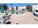 Inviting outdoor swimming pool area with lounge chairs, tables, and a palm tree, surrounded by well-maintained landscaping at 1815 Restful Dr # N-27, Bradenton, FL 34207