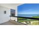 Balcony with stunning ocean views on a clear day, featuring a tiled floor and a partial view of a coastal landscape at 2020 Harbourside Dr # 454, Longboat Key, FL 34228