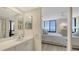 Bathroom vanity leading to the bedroom with views of the ocean at 2020 Harbourside Dr # 454, Longboat Key, FL 34228