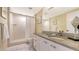 Bright bathroom featuring a walk-in shower and a granite-topped vanity with plenty of storage space at 2020 Harbourside Dr # 454, Longboat Key, FL 34228