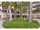 Condominium building exterior featuring lush tropical landscaping and architecture at 2020 Harbourside Dr # 454, Longboat Key, FL 34228