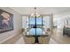 An open dining room with a modern light fixture and scenic water views at 2020 Harbourside Dr # 454, Longboat Key, FL 34228