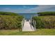Private dock access through lush green vegetation leading to open water at 2020 Harbourside Dr # 454, Longboat Key, FL 34228