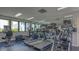 Well-equipped gym featuring modern cardio machines, mirrored wall, and natural light at 2020 Harbourside Dr # 454, Longboat Key, FL 34228