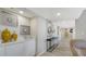 Hallway with wet bar, modern art and sleek design elements at 2020 Harbourside Dr # 454, Longboat Key, FL 34228
