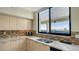 Close up on the kitchen sink with beautiful cabinetry, backsplash, and granite countertops at 2020 Harbourside Dr # 454, Longboat Key, FL 34228