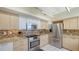 Modern kitchen with stainless steel appliances, tiled backsplash, and ample counter space at 2020 Harbourside Dr # 454, Longboat Key, FL 34228