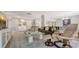 Bright living room with modern decor featuring stylish seating and a glass coffee table on top of a blue patterned area rug at 2020 Harbourside Dr # 454, Longboat Key, FL 34228