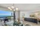 Open living space with modern decor, a view of the ocean, and contemporary lighting at 2020 Harbourside Dr # 454, Longboat Key, FL 34228