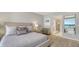 Bright and airy bedroom with mirrored closet doors, boasting a stylish side table and ocean views at 2020 Harbourside Dr # 454, Longboat Key, FL 34228