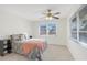 Comfortable bedroom featuring a ceiling fan and natural light from large windows at 206 Elliot Ave # 137, Sarasota, FL 34232