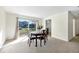 Bright dining area with a round wooden table set for four, and sliding glass doors to the outside at 206 Elliot Ave # 137, Sarasota, FL 34232