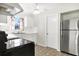 Bright eat-in kitchen featuring a stainless steel refrigerator and tiled floors at 206 Elliot Ave # 137, Sarasota, FL 34232