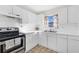 Bright kitchen with stainless steel appliances and white cabinets at 206 Elliot Ave # 137, Sarasota, FL 34232