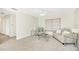 Bright living room featuring neutral walls, plush carpet, and comfortable seating near a window with blinds at 206 Elliot Ave # 137, Sarasota, FL 34232