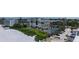 Aerial view of a beachfront condo building with tennis court, pool, parking, and beach access at 2675 Gulf Of Mexico Dr # 403, Longboat Key, FL 34228
