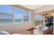 A seating area with wicker furniture leading out to a balcony with beautiful ocean views at 2675 Gulf Of Mexico Dr # 403, Longboat Key, FL 34228