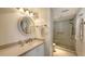 Bathroom with granite countertop, shower, and toilet, providing a clean and functional space at 2675 Gulf Of Mexico Dr # 403, Longboat Key, FL 34228