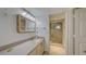 Bathroom with vanity featuring a large mirror and a glass enclosed shower at 2675 Gulf Of Mexico Dr # 403, Longboat Key, FL 34228