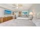 Bright bedroom featuring two beds, TV, ceiling fan, and beach artwork for a relaxing coastal vibe at 2675 Gulf Of Mexico Dr # 403, Longboat Key, FL 34228